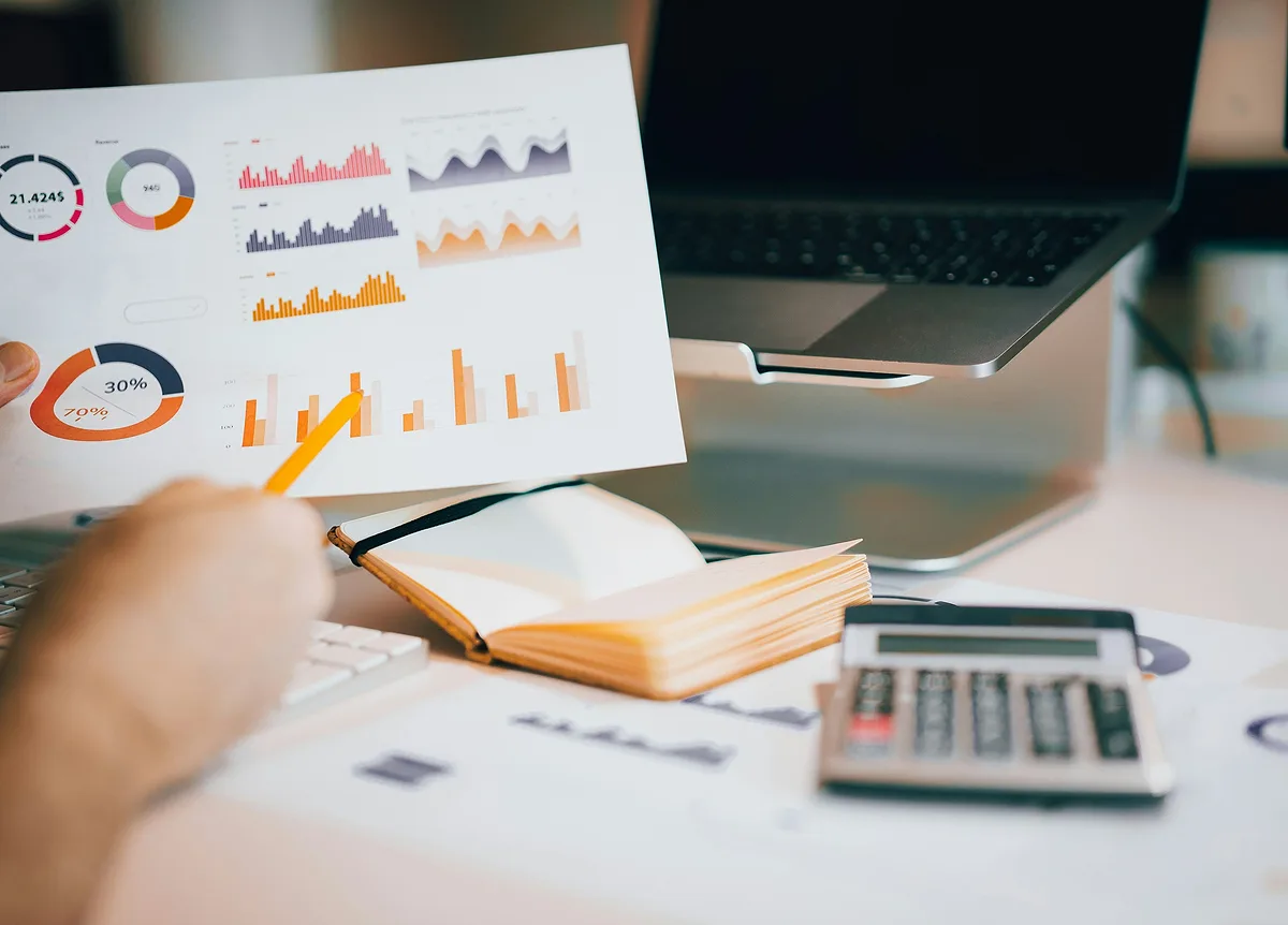 Management accounts and charts reviewed at a desk